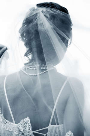 The bride in a veil expecting the groomの写真素材