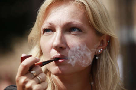 The woman with a smoking tubeの写真素材