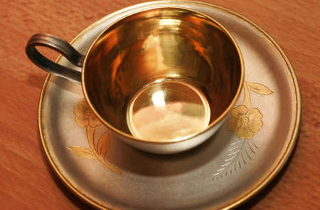 Silver coffee cup with gildingの写真素材
