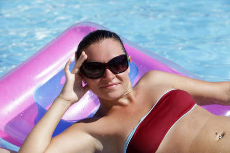 Beautiful woman enjoying summer in the pool