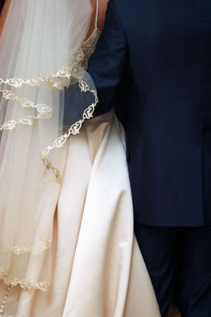 The groom embraces the brideの写真素材