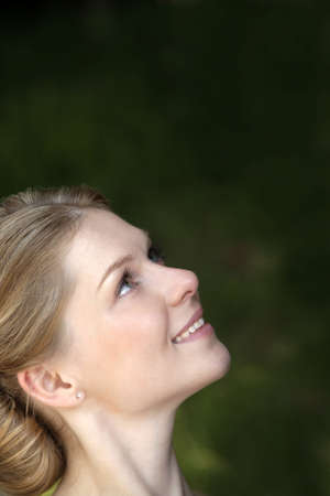 Portrait of the young woman on a green background