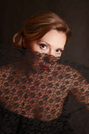 The woman closed by a black translucent fabricの写真素材