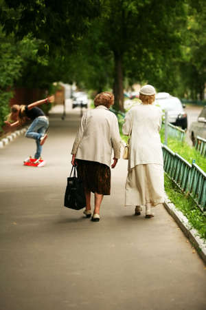 Two old women on street of cityの写真素材