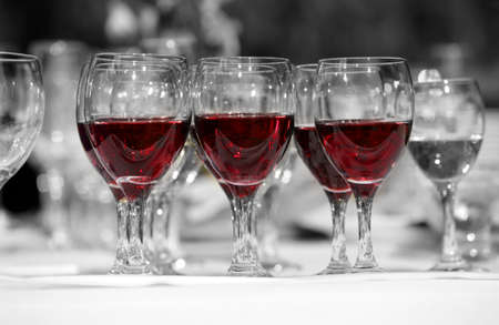 Wine glasses with red wine in linesの写真素材