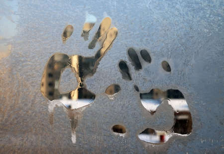 freezing glass with a print of a handsの写真素材