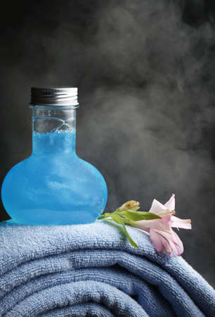 Blue towels and bottles with blue shampoo on a background pairの写真素材