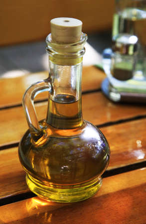 Glass bottle with a cover filled olive oilの写真素材