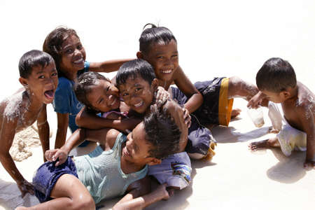 PHILIPPINES, Island BORACAY - 21 October, 2008: Five years' and seven-year cheerful unidentified Philippine children at coast of ocean. Island Boracay, Philippines, 21 October, 2008 on.のeditorial素材