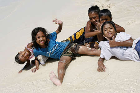 PHILIPPINES, Island BORACAY - 21 October, 2008: Five years' and seven-year cheerful unidentified Philippine children at coast of ocean. Island Boracay, Philippines, 21 October, 2008.のeditorial素材