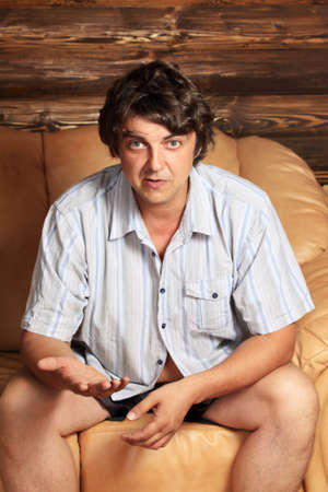 Adult man in domestic conditions in an armchairの写真素材