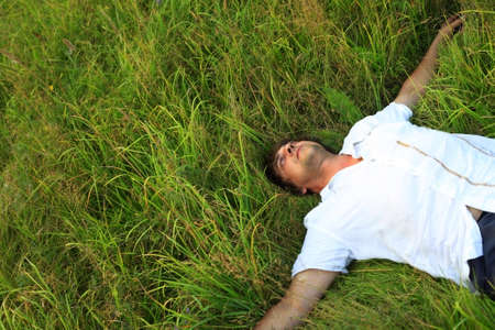 Adult the man weakening in a grassの写真素材