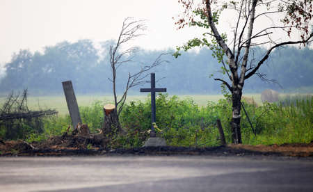 Old wooden crosses at edge of roadの写真素材