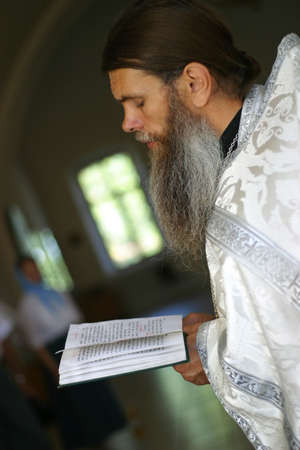 RUSSIA, MOSCOW, AUGUST, 20: The priest with the Bible ceremony of christening in August, 20, 2005 in Moscowのeditorial素材