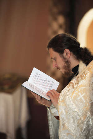 RUSSIA, MOSCOW, MAY, 31: Priest with the Bible on ceremony of christening in the Moscow churchin Moscow, 31 May 2009のeditorial素材