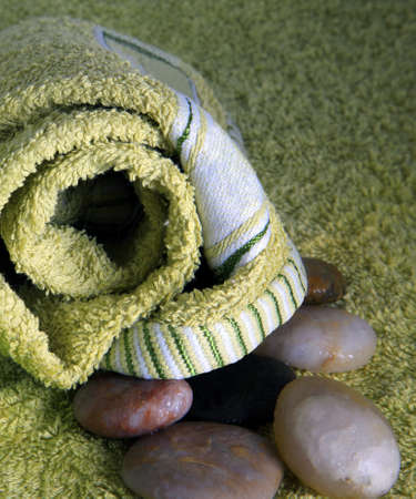 Green towel and stones for massageの写真素材