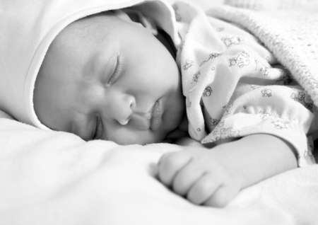 New born baby girl peacefully sleepingの写真素材