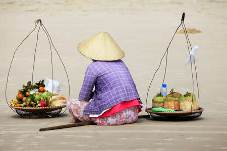 The Asian woman selling fruit on seacoastの写真素材