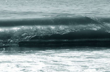Big wave crashes on to the shoreの写真素材