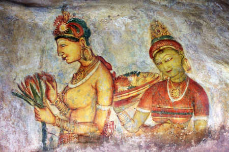 Two Sigiriya maiden with flowers: one of the 5th century frescoes at the ancient rock fortress of Sigiriya, a UNESCO World Heritage Site in Sri Lanka.のeditorial素材