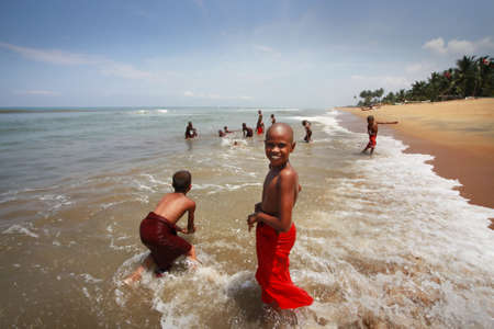 SRI LANKA, KALATURA - 08 APRIL, 2011: School of the Buddhism. Young Buddhists bathe at ocean in a break between lessons 08 april in Kalatura, Sri lanka (Ceylon)のeditorial素材