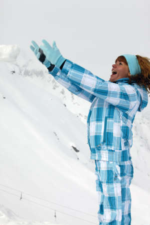 The happy girl in a blue ski suitの写真素材