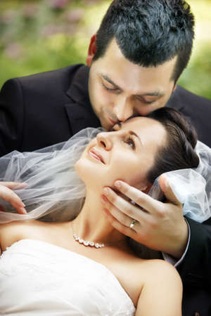 Newly-married couple in parkの写真素材