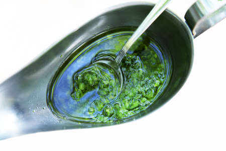 Natural sauce in a metal cup isolated in whiteの写真素材