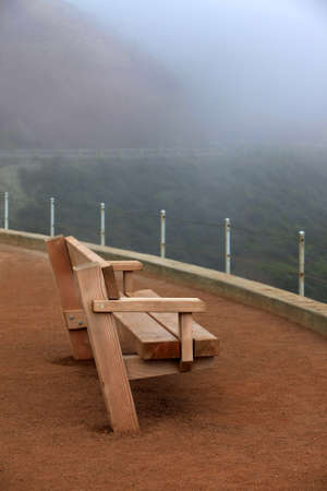 Wooden bench in a fog on a viewing platform in San Franciscoの写真素材