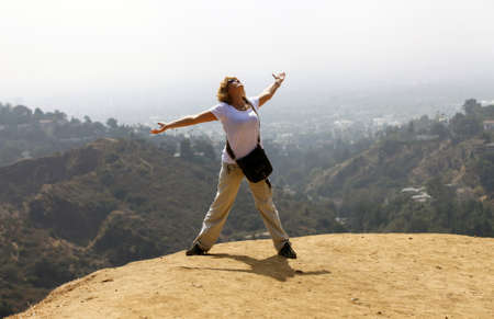 The woman - tourist on the Hollywood hill on background Los Angelesの写真素材