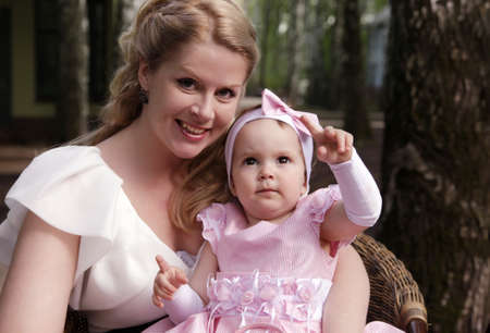 Portrait of beautiful happy smiling mother with baby outdoor, on nature