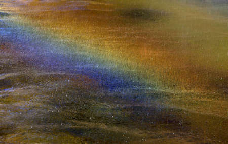 Sparks of water and rainbow above itの写真素材