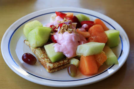 Pancakes with different fruit and yoghurtの写真素材