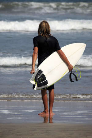 Surfer on a coastline expecting the big wave. Bali