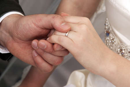 Hand of the groom and the bride with wedding rings