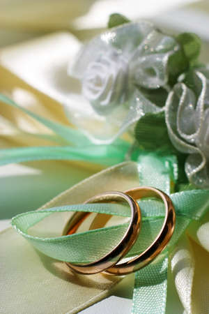 Wedding rings on a blue satiny fabricの写真素材