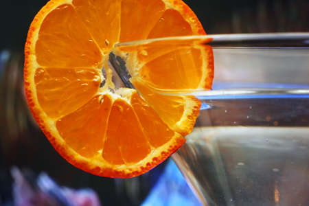 Glass with a plate orange on a dark blue backgroundの写真素材