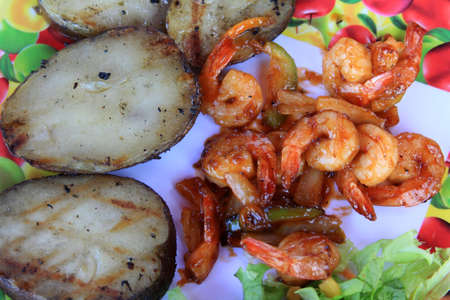 prawn in sweet red sauce with a potato and vegetablesの写真素材