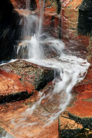 Tropical waterfall in red stoneの写真素材