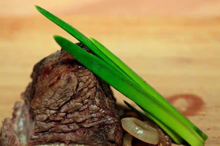 Roast red beef meat bbq bloc served on black plate with green chivesの写真素材