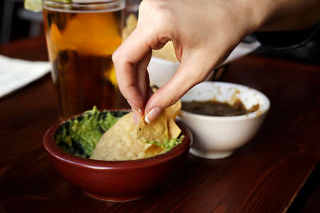 An avocado - based salsa called guacamole with chipsの写真素材