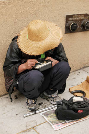 SAN FRANCISCO, USA - 15 SEPTEMBER, 2011: Chinese homeless woman eats in the streets of San Francisco...