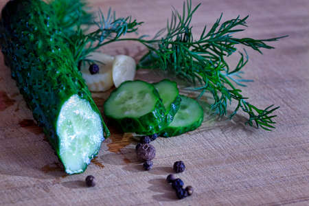 Pickled cucumber still life on old plankの写真素材