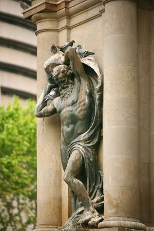 Statue adorns the building in Barcelonaの写真素材