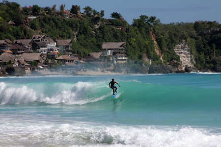 Young men - the surfer in ocean. Bali. Indonesia