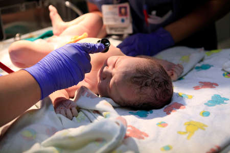 The first minutes of life of the newborn girlの写真素材