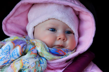 Beautiful small kid girl in pink hatの写真素材