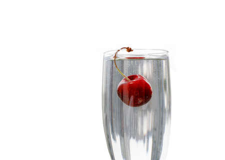ripe cherry in glass on white backgroundの写真素材