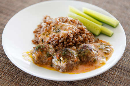 Buckwheat with small meat balls, red souse and fresh cucumbersの写真素材