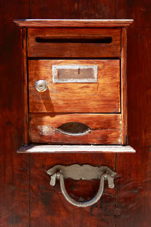 Wooden old door with iron handle and mailboxの写真素材